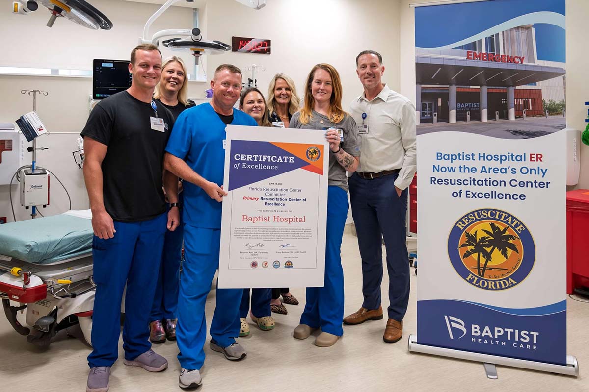 A group of medical professionals holding up a certificate of excellence for Baptist Hospital